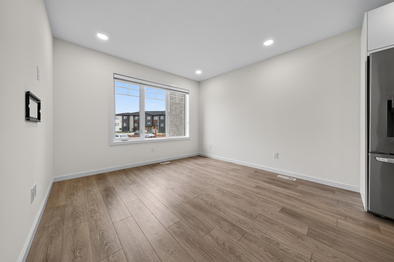 The living area, window and fridge wall