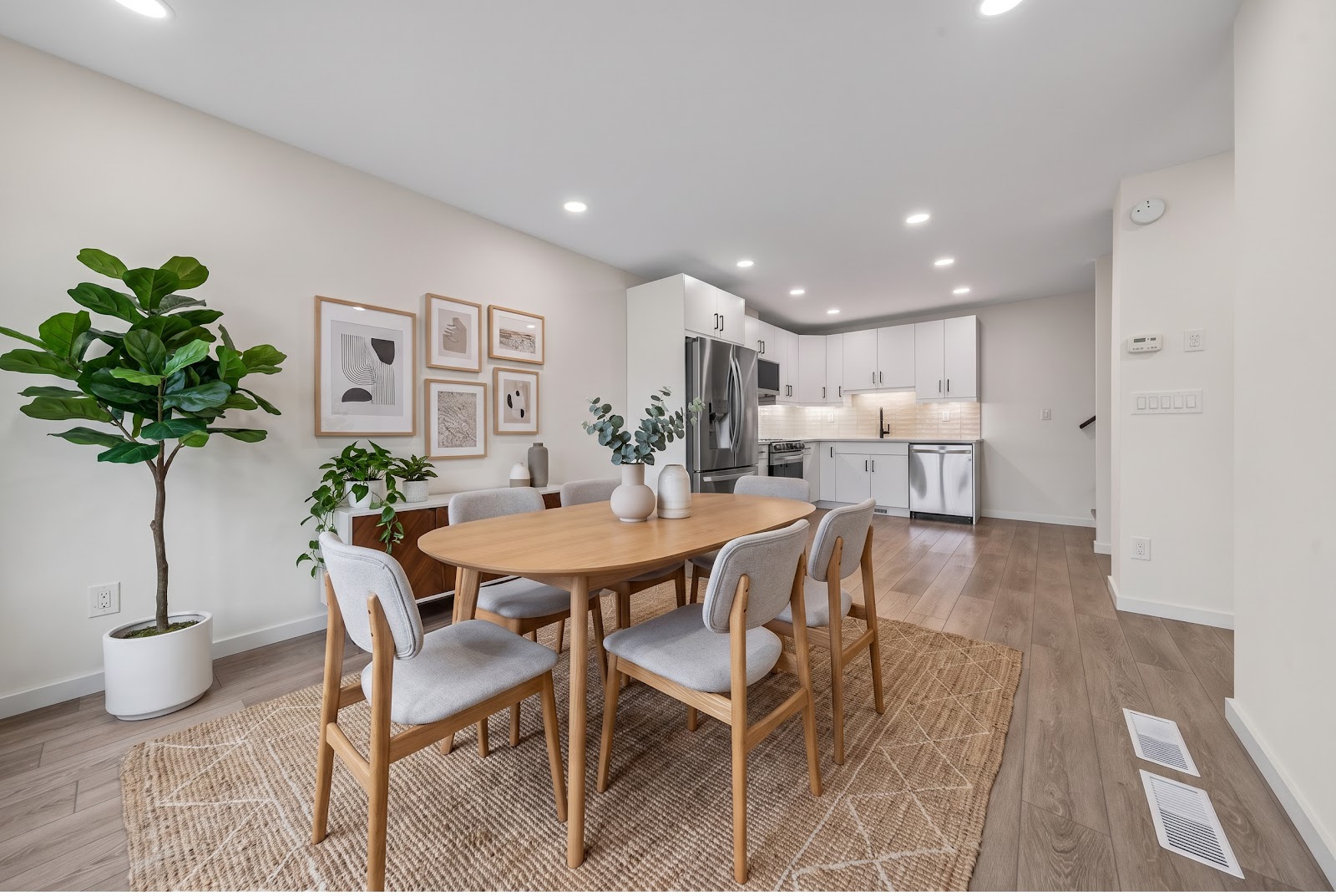 Dining, with the kitchen beyond, staged