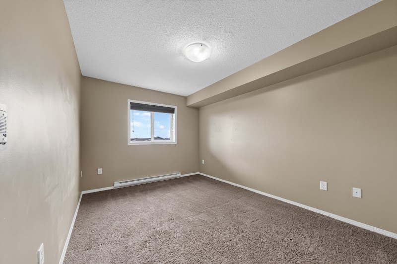 A carpeted bedroom with its own window