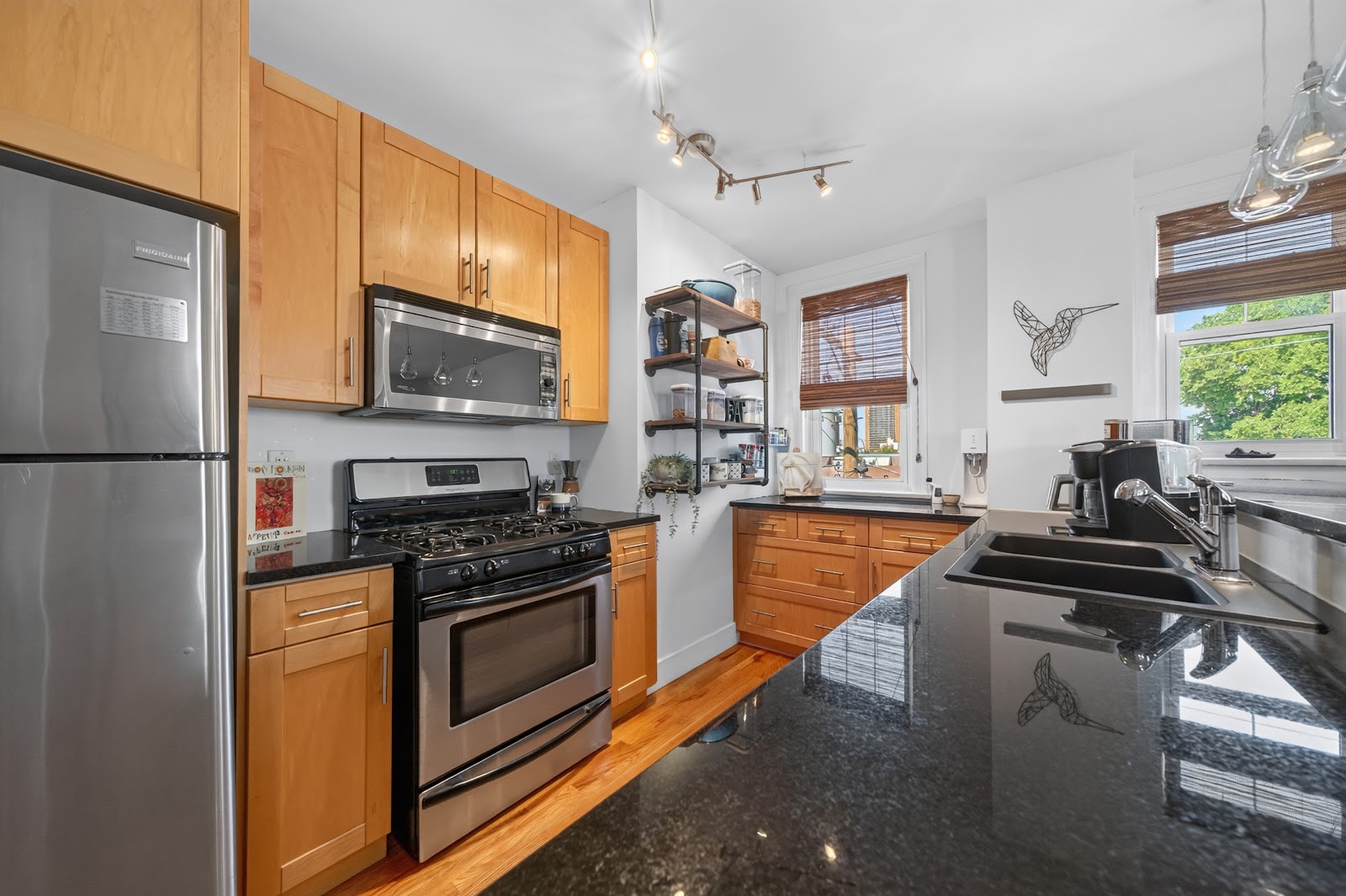 Kitchen with granite counters, gas cook top and stainless appliances
