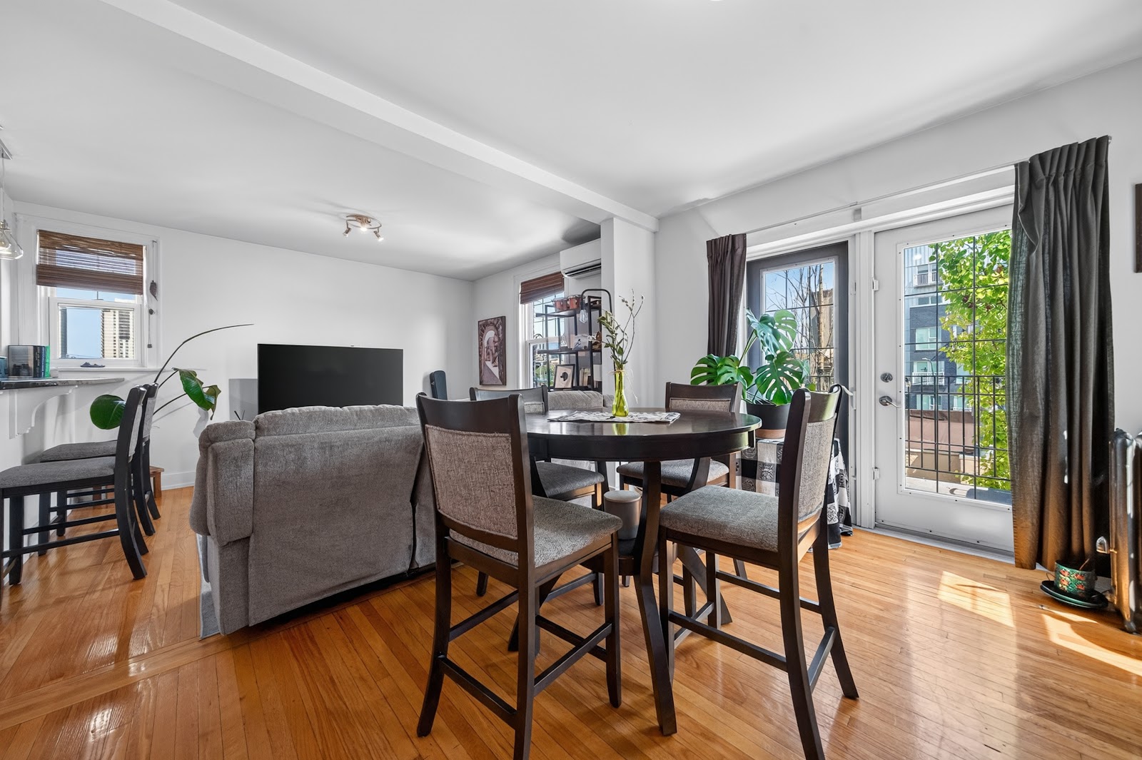 Open living and dining area with windows on two sides